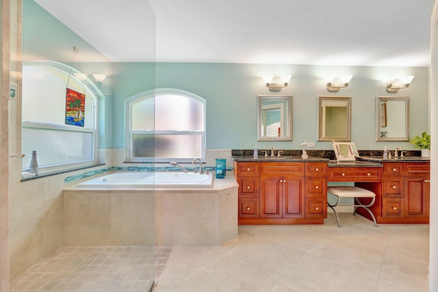 full bath with double vanity, tile patterned floors, a sink, and a garden tub