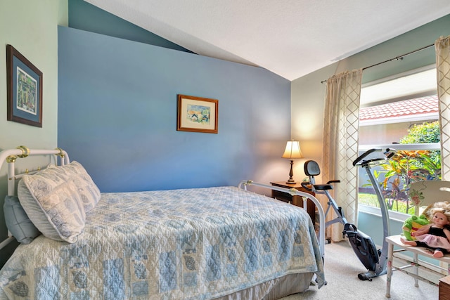 carpeted bedroom featuring vaulted ceiling and multiple windows