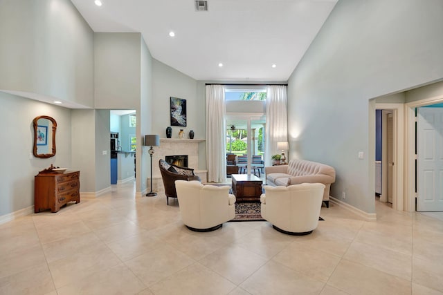 living room featuring baseboards, light tile patterned floors, and high vaulted ceiling