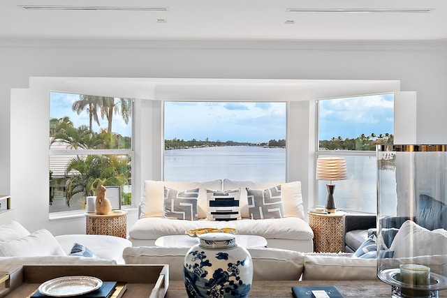 living room featuring ornamental molding and a water view