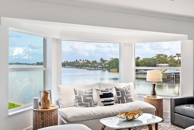 sunroom featuring a wealth of natural light and a water view