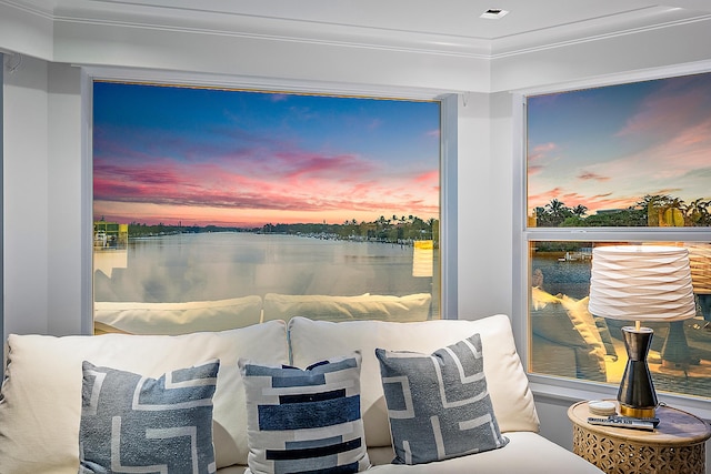 bedroom featuring crown molding and a water view