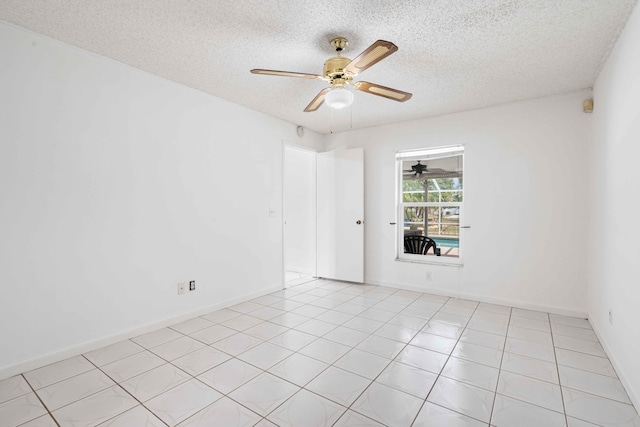 unfurnished room with baseboards, a ceiling fan, and a textured ceiling