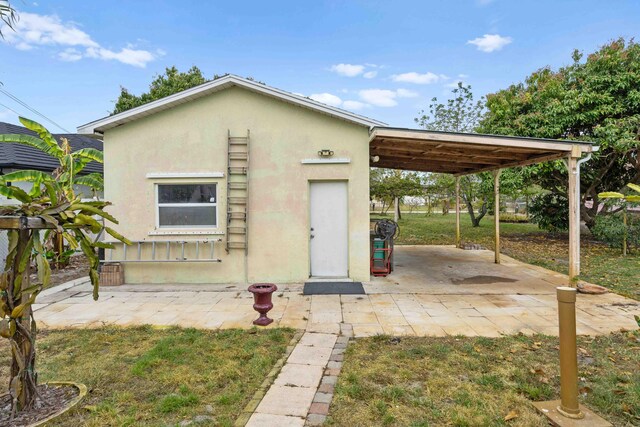 exterior space with a patio, stucco siding, and an attached carport