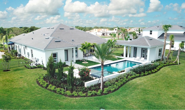 20128 Se Bridgewater Drive Oakley Model, Jupiter, FL 33458 - rear view of house featuring a lawn, fence, and a tile roof