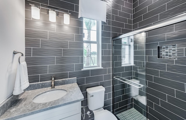 20128 Se Bridgewater Drive Oakley Model, Jupiter, FL 33458 - full bathroom featuring vanity, tile walls, a shower stall, and toilet