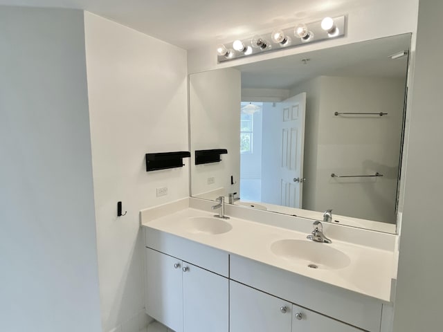 full bathroom with double vanity and a sink