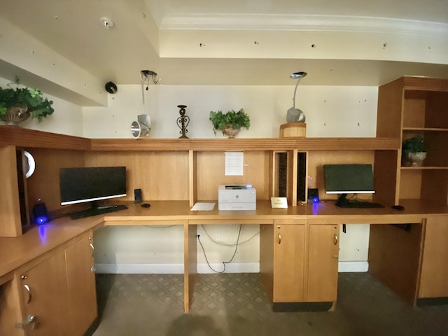 office space with ornamental molding and built in desk