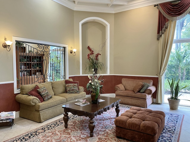tiled living room featuring crown molding, coffered ceiling, wainscoting, and a towering ceiling