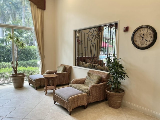 living area featuring baseboards and tile patterned flooring