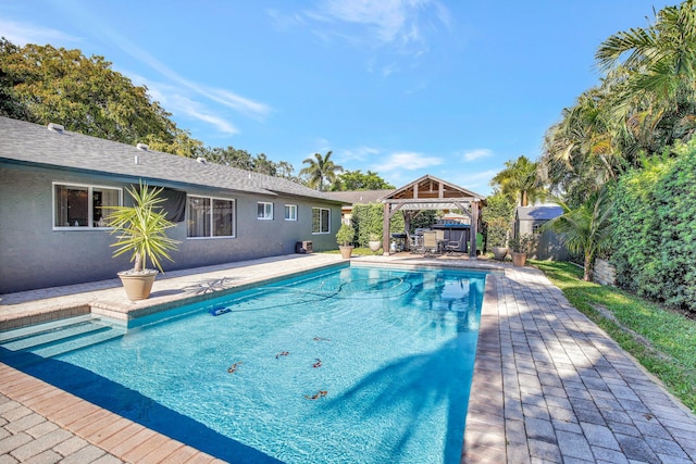 outdoor pool featuring a gazebo and a patio area