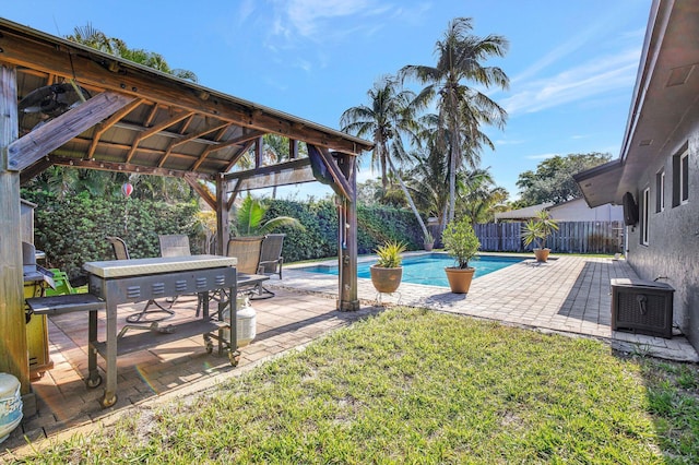 view of yard featuring a patio, a gazebo, a fenced in pool, and a fenced backyard