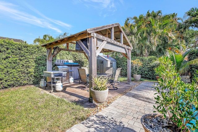 view of patio / terrace with a storage shed, a hot tub, an outbuilding, and a gazebo