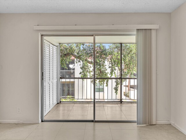 614 NW 13th St Unit 27, Boca Raton, FL 33486 - doorway with tile patterned floors and baseboards
