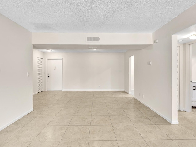 614 NW 13th St Unit 27, Boca Raton, FL 33486 - spare room featuring light tile patterned flooring, a textured ceiling, visible vents, and baseboards