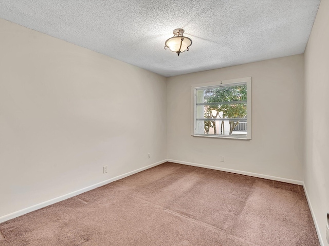 614 NW 13th St Unit 27, Boca Raton, FL 33486 - carpeted empty room with baseboards and a textured ceiling
