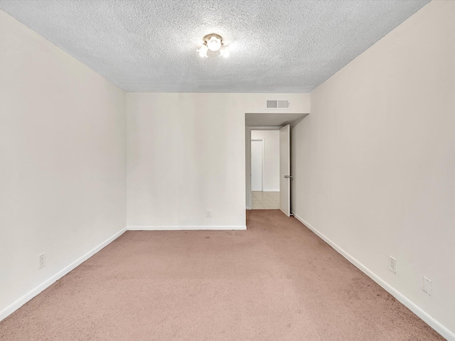 614 NW 13th St Unit 27, Boca Raton, FL 33486 - spare room with a textured ceiling, visible vents, light carpet, and baseboards