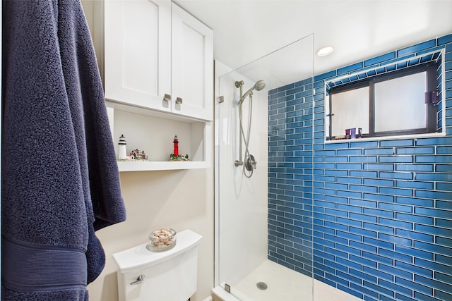 full bath featuring a stall shower and toilet