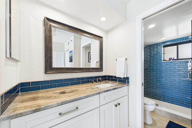 full bath featuring vanity, toilet, recessed lighting, and a stall shower