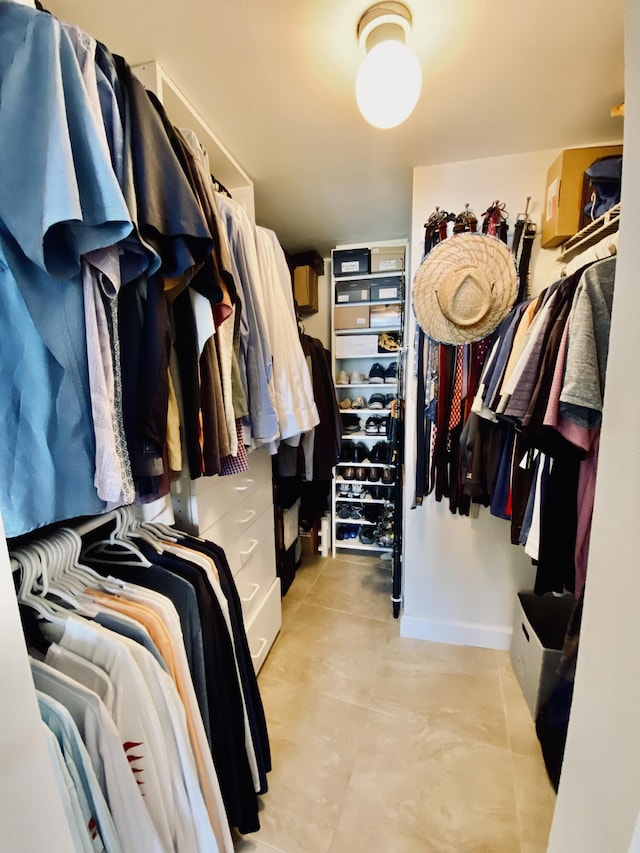 spacious closet featuring light tile patterned flooring