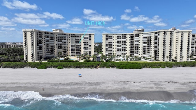 view of property with a beach view and a water view