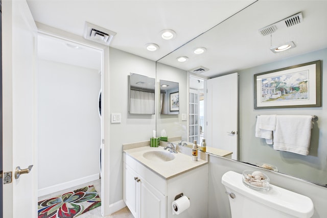 bathroom featuring visible vents, baseboards, and toilet