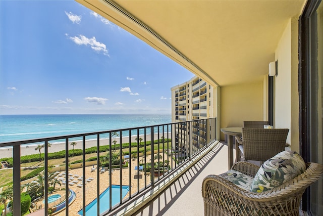 balcony with a water view and a beach view