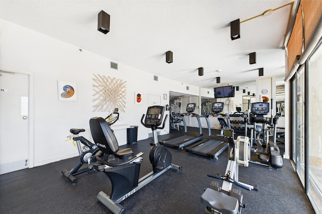 exercise room featuring visible vents and a textured ceiling