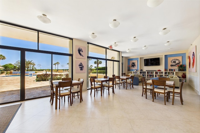 dining room featuring light tile patterned floors and expansive windows