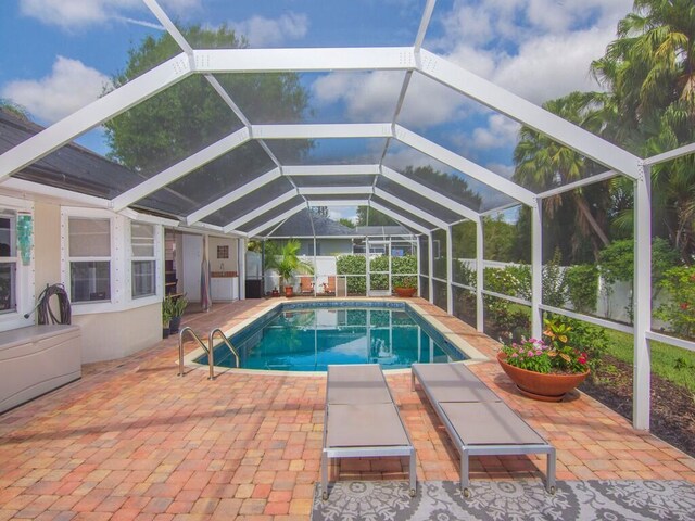 view of pool with a fenced in pool, a lanai, and a patio area