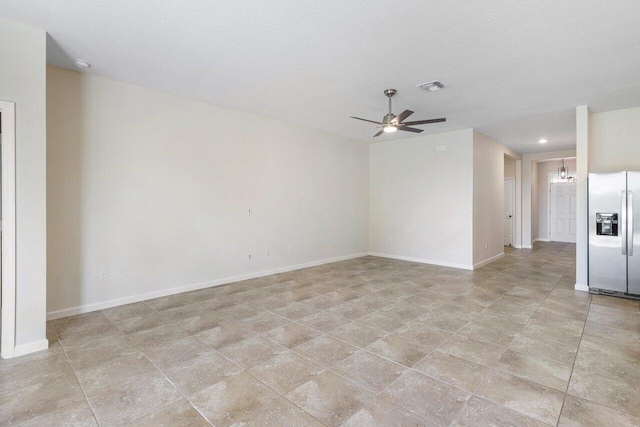 6056 NW Regent St, Port Saint Lucie, FL 34983 - unfurnished room featuring visible vents, baseboards, and ceiling fan with notable chandelier
