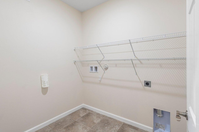 6056 NW Regent St, Port Saint Lucie, FL 34983 - clothes washing area with laundry area, baseboards, hookup for a washing machine, hookup for an electric dryer, and hookup for a gas dryer