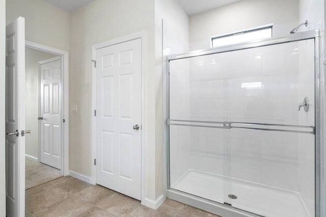 6056 NW Regent St, Port Saint Lucie, FL 34983 - bathroom with baseboards and a shower stall