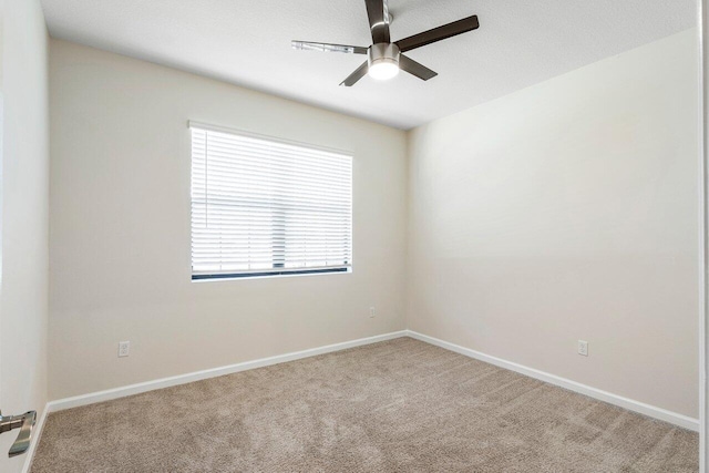 6056 NW Regent St, Port Saint Lucie, FL 34983 - empty room with carpet floors, a ceiling fan, and baseboards