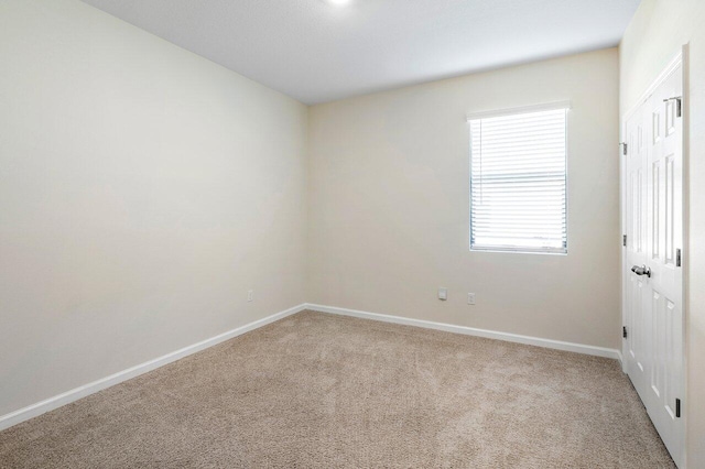 6056 NW Regent St, Port Saint Lucie, FL 34983 - carpeted empty room with baseboards