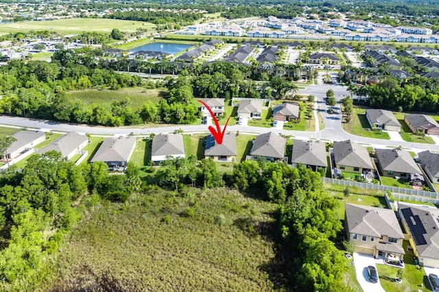 6056 NW Regent St, Port Saint Lucie, FL 34983 - birds eye view of property with a water view and a residential view