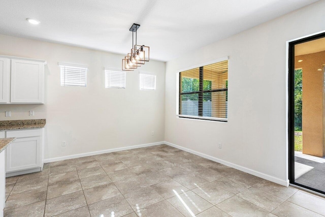 6056 NW Regent St, Port Saint Lucie, FL 34983 - unfurnished dining area featuring baseboards