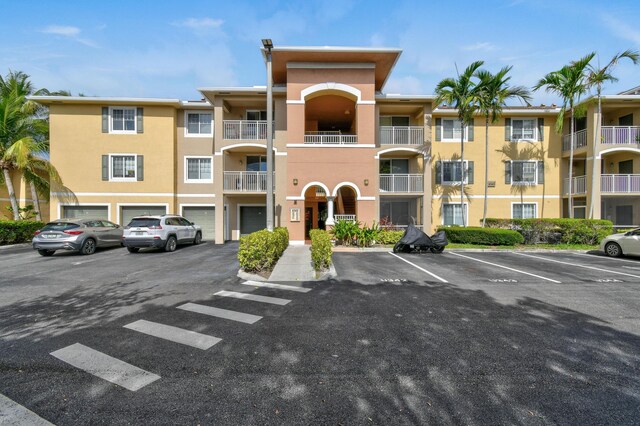 6565 Emerald Dunes Dr Unit 108, West Palm Beach, FL 33411 - interior space featuring track lighting, baseboards, dark wood finished floors, and visible vents