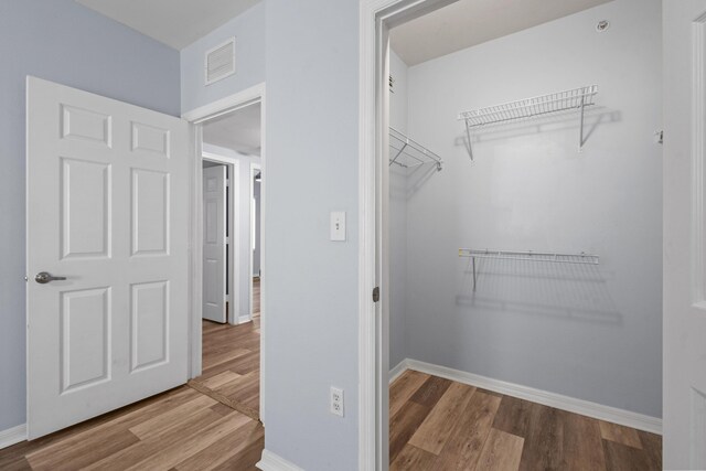 6565 Emerald Dunes Dr Unit 108, West Palm Beach, FL 33411 - spacious closet featuring visible vents and wood finished floors