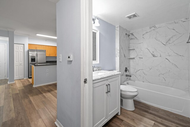 6565 Emerald Dunes Dr Unit 108, West Palm Beach, FL 33411 - bathroom featuring vanity, toilet, shower / washtub combination, wood finished floors, and visible vents
