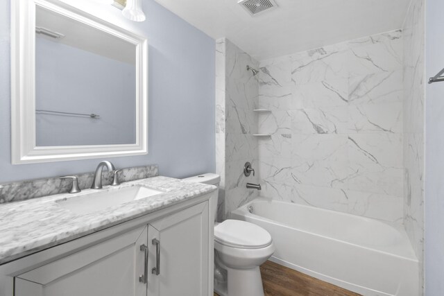 6565 Emerald Dunes Dr Unit 108, West Palm Beach, FL 33411 - full bathroom featuring visible vents, vanity, wood finished floors, toilet, and shower / tub combination