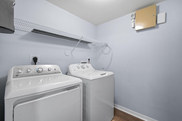 6565 Emerald Dunes Dr Unit 108, West Palm Beach, FL 33411 - laundry room featuring baseboards, laundry area, wood finished floors, and washing machine and clothes dryer