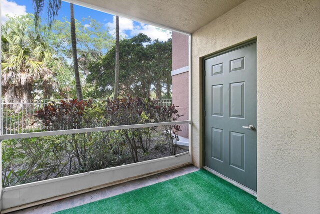 6565 Emerald Dunes Dr Unit 108, West Palm Beach, FL 33411 - entrance to property with a balcony and stucco siding