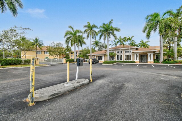6565 Emerald Dunes Dr Unit 108, West Palm Beach, FL 33411 - uncovered parking lot featuring fence and french doors