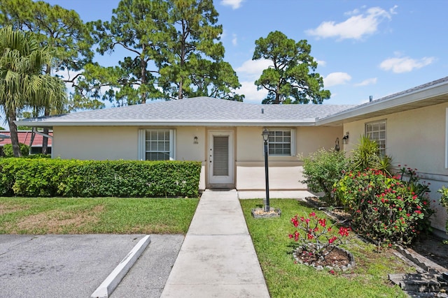 208 Cape Cod Cir, Lake Worth, FL 33467 - ranch-style home featuring stucco siding, a front lawn, uncovered parking, and a shingled roof