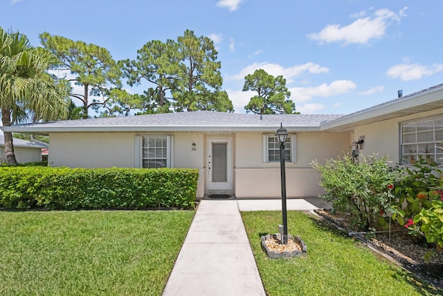 208 Cape Cod Cir, Lake Worth, FL 33467 - view of front of house featuring stucco siding and a front yard