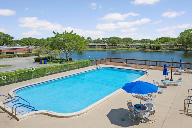 208 Cape Cod Cir, Lake Worth, FL 33467 - community pool featuring fence, a water view, a patio area, and view of scattered trees