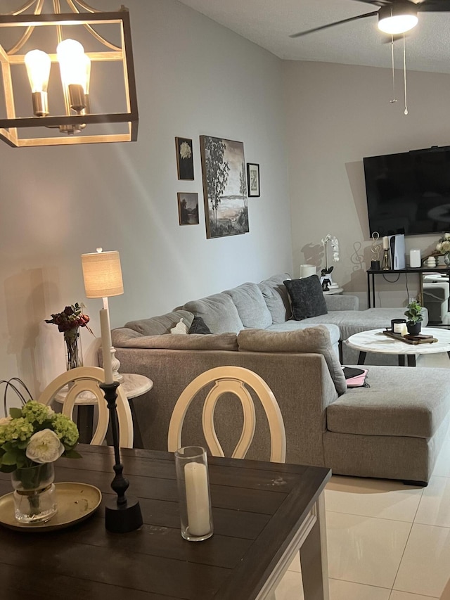 living room with ceiling fan with notable chandelier