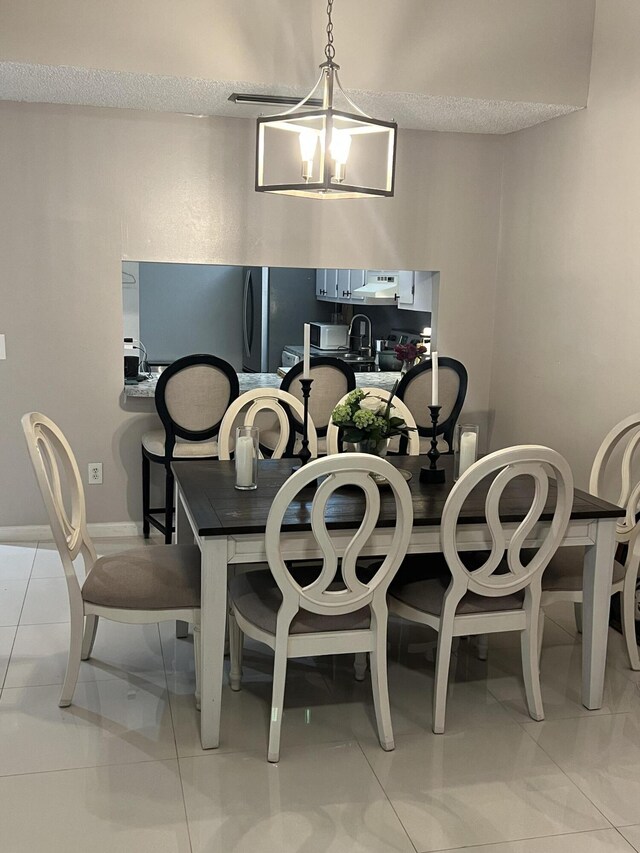 dining room with baseboards and an inviting chandelier