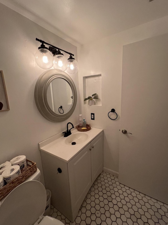 half bathroom featuring toilet and vanity